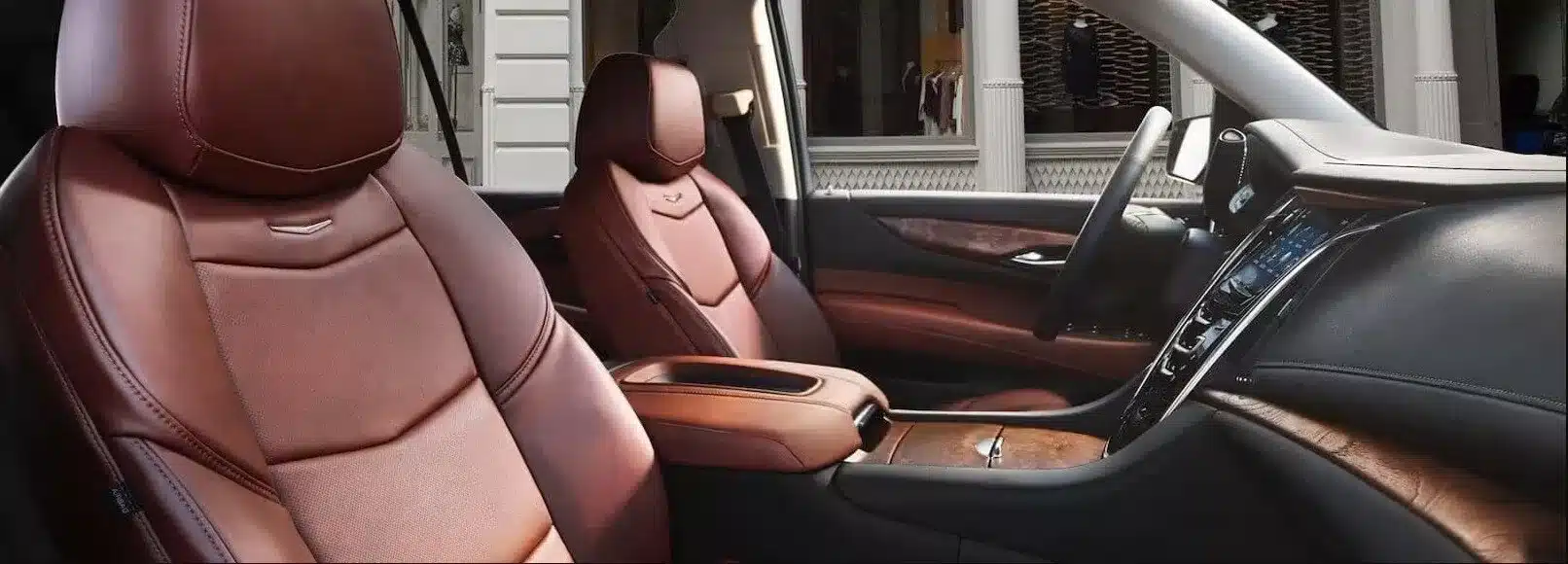 Luxurious SUV interior with brown leather seats and modern dashboard design.