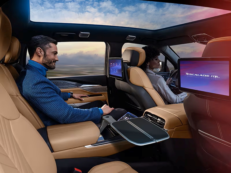 Luxury SUV interior with leather seats, panoramic sunroof, and rear seat entertainment screens active.