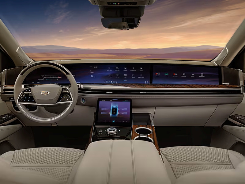 Luxury car interior showcasing a dashboard with digital displays and modern steering wheel.